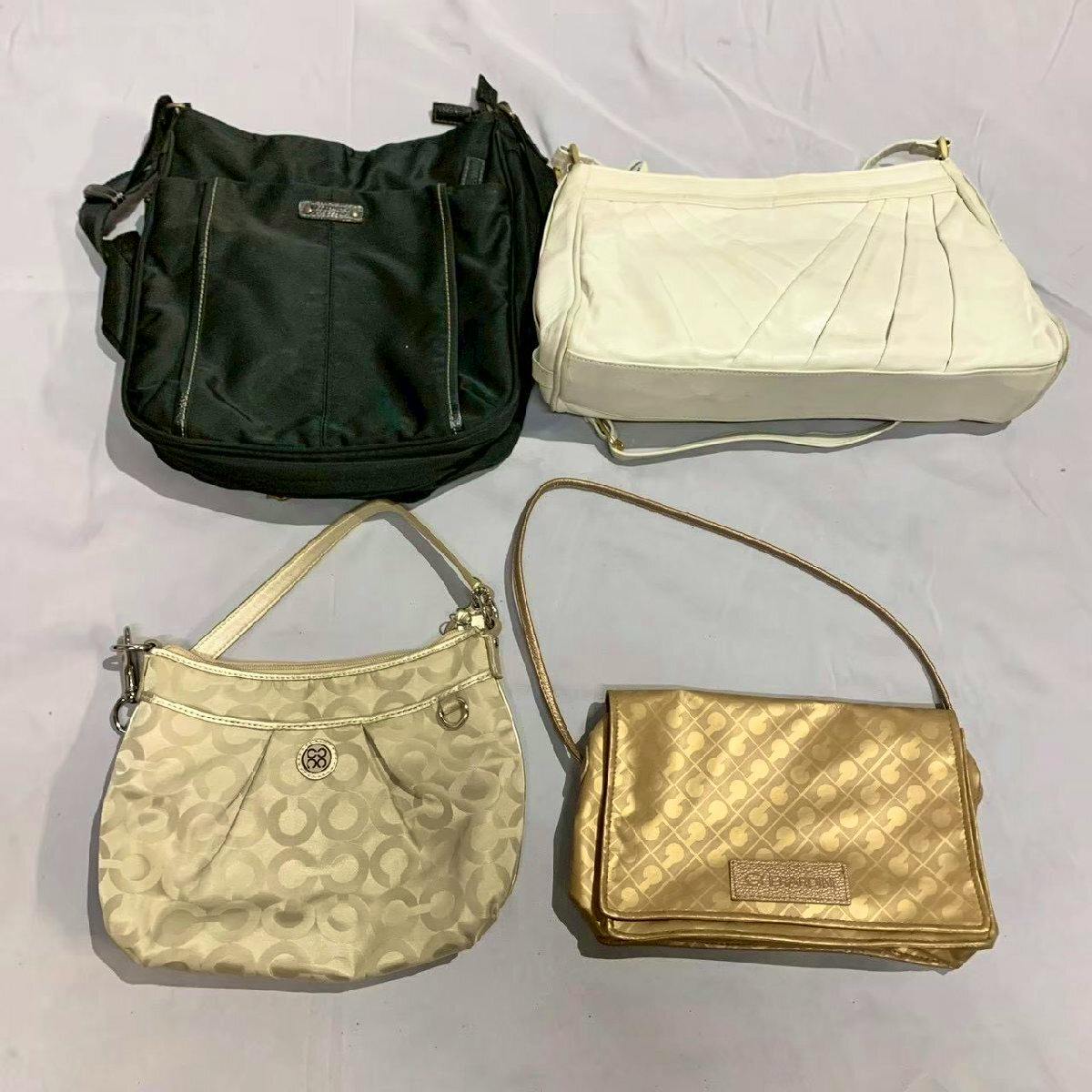 Four handbags and small shoulder bags arranged on a light cloth background.