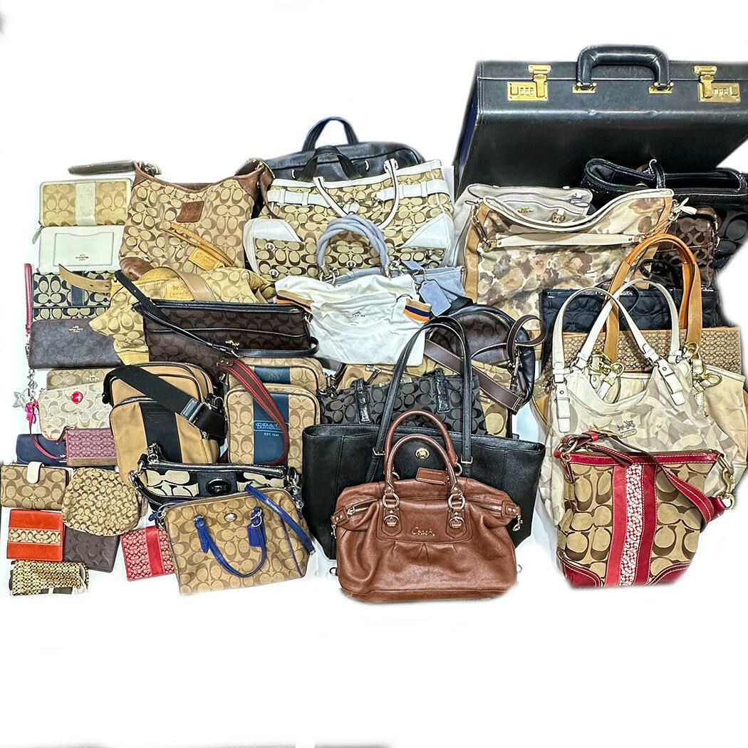 A group of Coach bags and accessories arranged together on a white background.