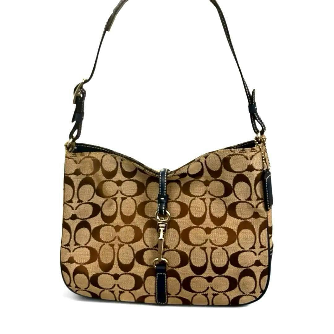 Front view of a COACH signature canvas and leather one-shoulder hobo bag with brown 'C' pattern and leather trim.