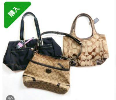 Three Coach signature canvas and leather handbags displayed together on a white background.
