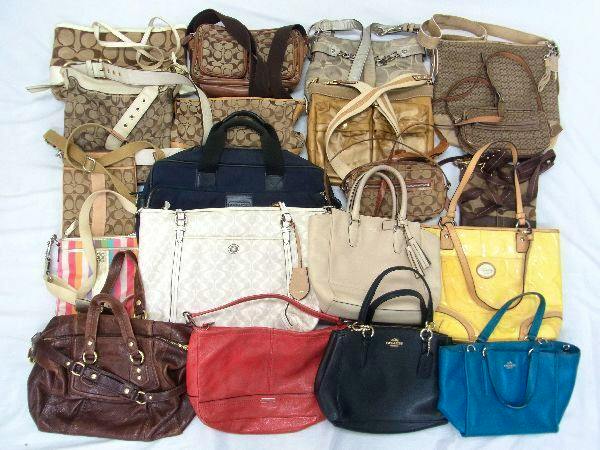 Assorted COACH tote, shoulder, and handbags arranged on a white surface showing the 20-piece set.