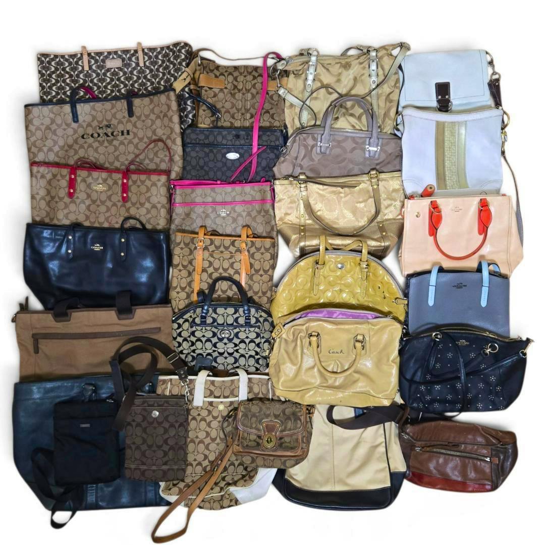 Top-down photo of the COACH bulk lot showing a large assortment of canvas and leather bags and totes arranged together.
