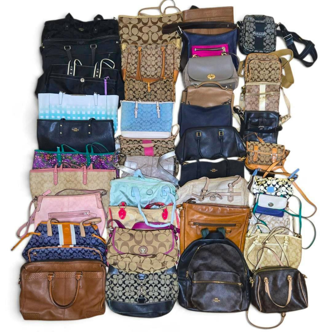 Top-down photo showing a large assortment of Coach bags and purses arranged together on a white background.