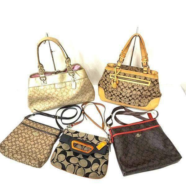 Five COACH signature canvas handbags and shoulder bags arranged on a white background.