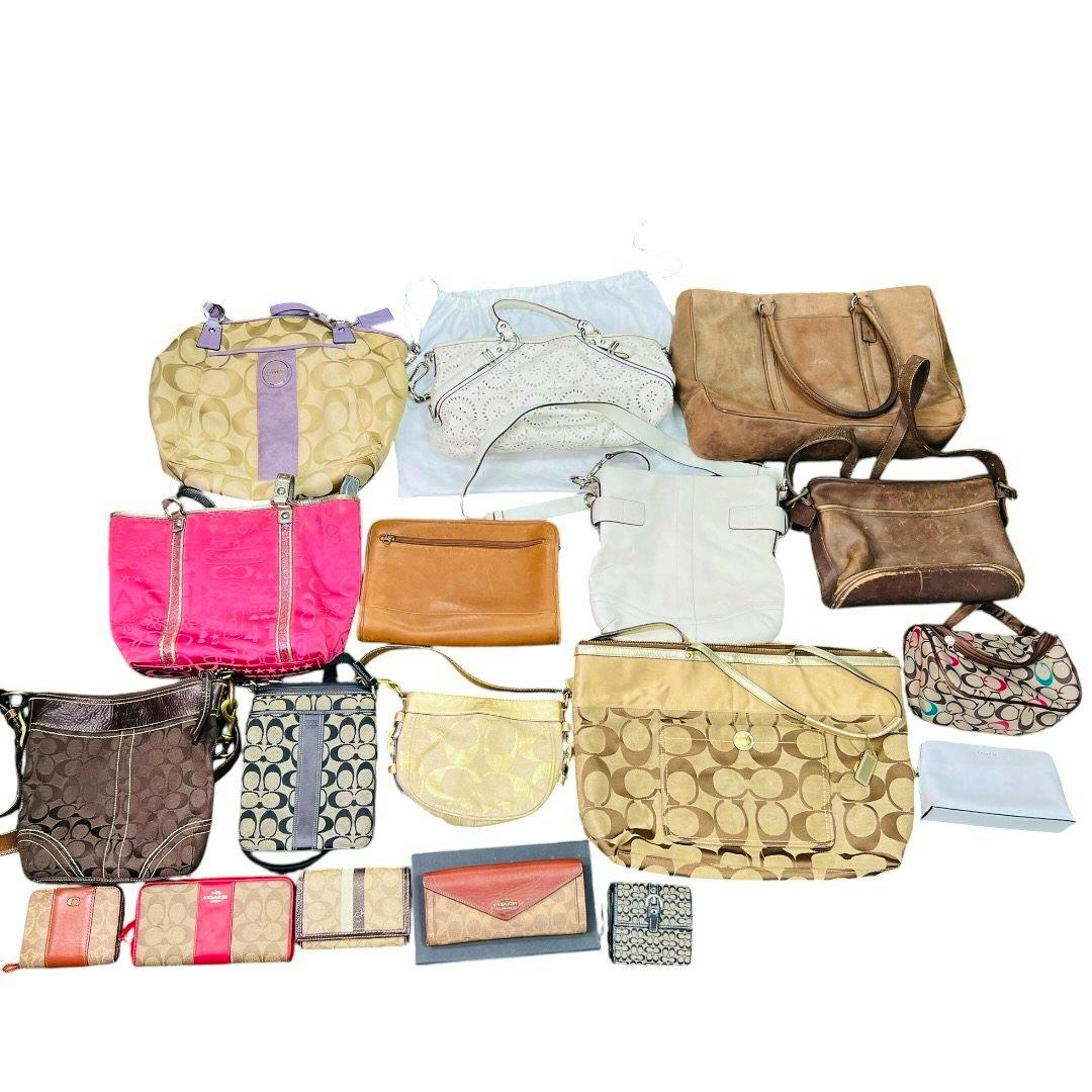 Multiple Coach handbags, shoulder bags, and wallets in various colors and signature C patterns arranged on a white background.