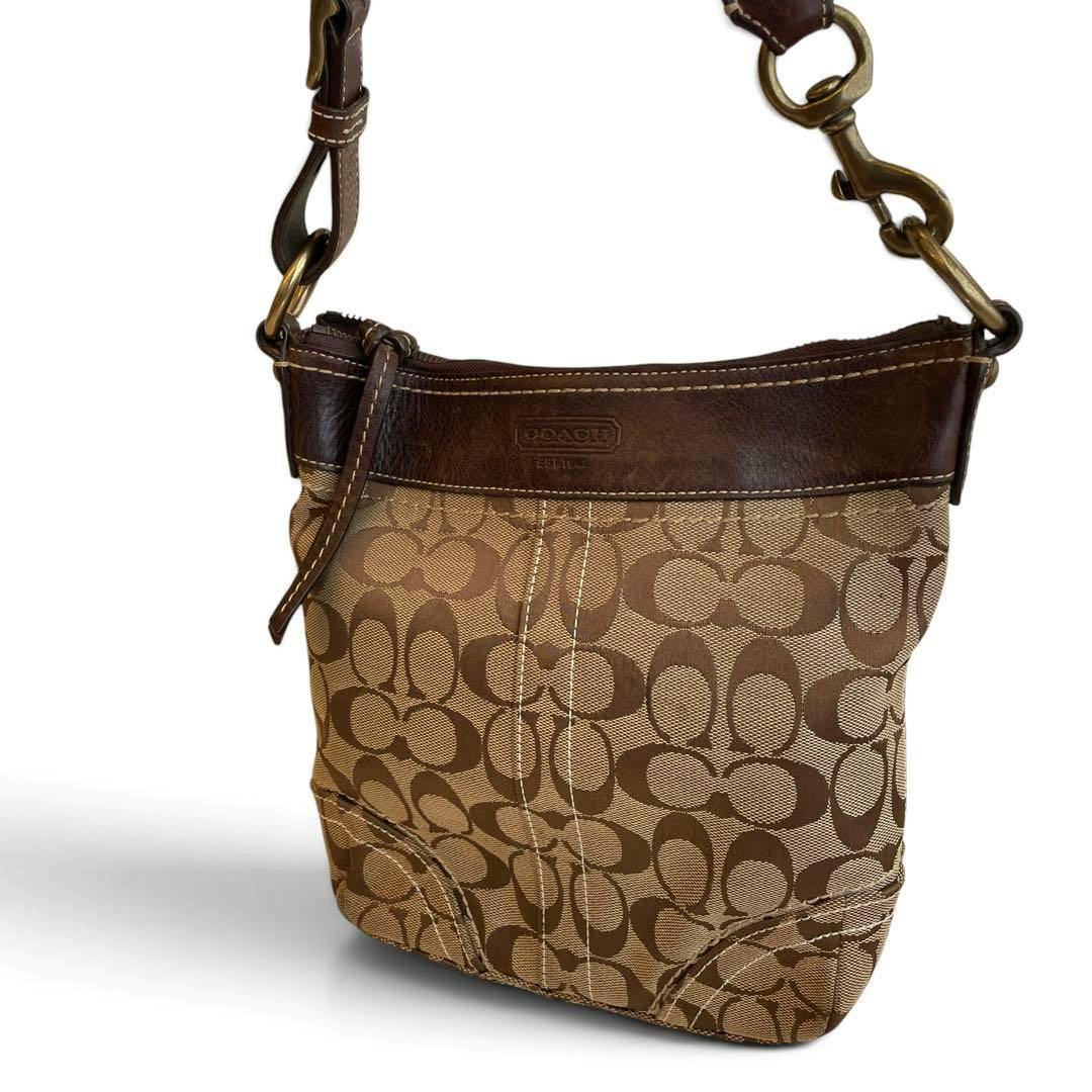 Brown Coach signature canvas shoulder bag with leather trim and shoulder strap shown from the front.