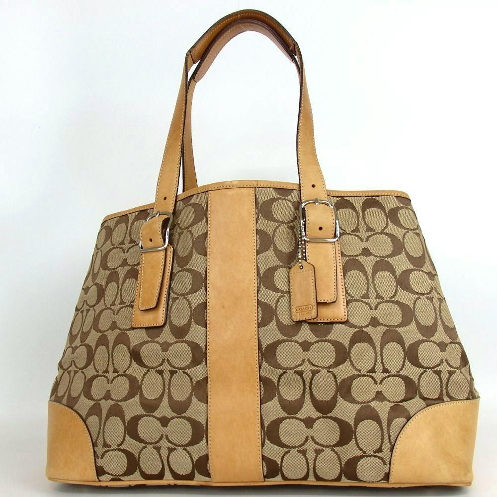 Front view of the Coach signature canvas and leather tote bag with leather straps and central leather panel.