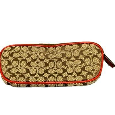 Brown Coach signature canvas pouch with red trim and zipper shown against a white background.