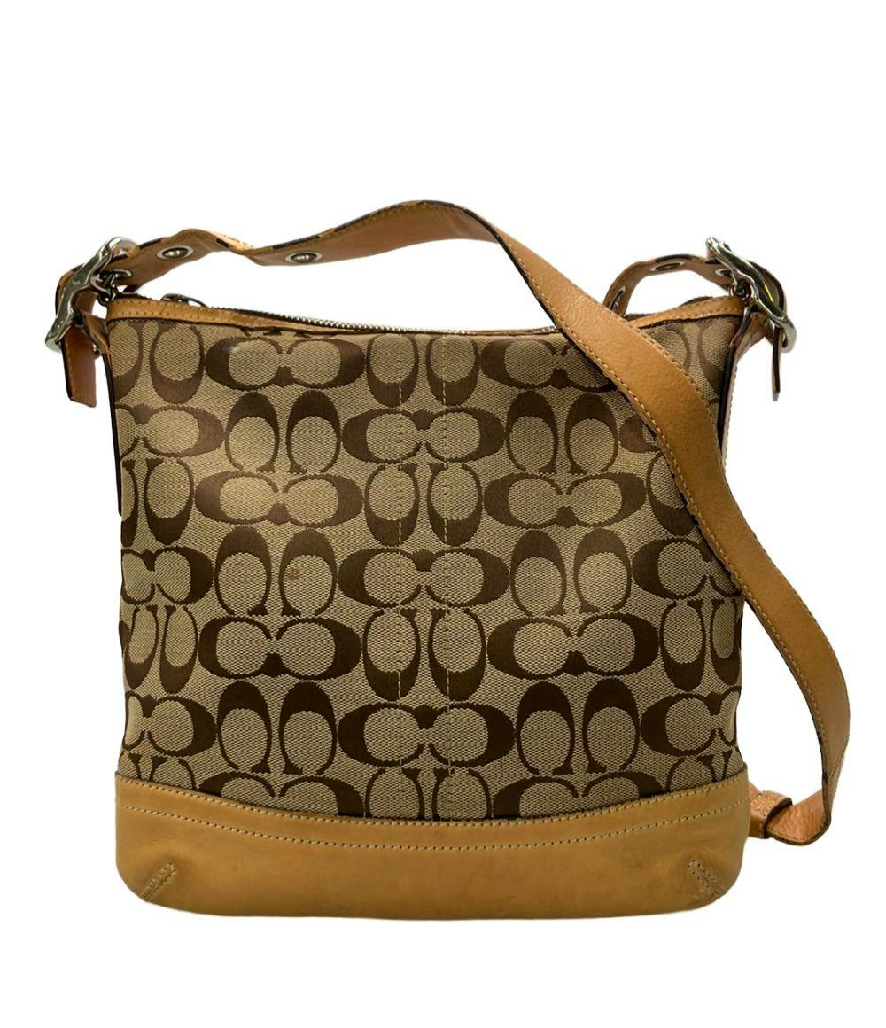 Front view of a Coach signature canvas shoulder bag with brown monogram pattern and tan leather trim and strap.