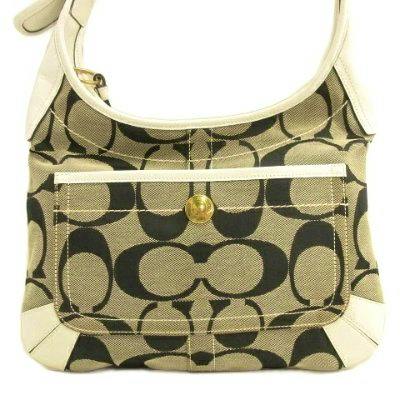 Front view of the Coach signature canvas shoulder bag showing large C pattern and a front pocket.