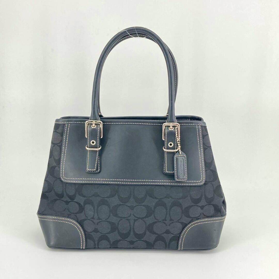 Front view of the black Coach signature canvas small carryall tote bag with leather trim and top handles.