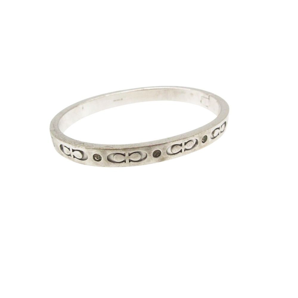Silver COACH signature hinged logo bangle bracelet with rhinestone accents on a white background.
