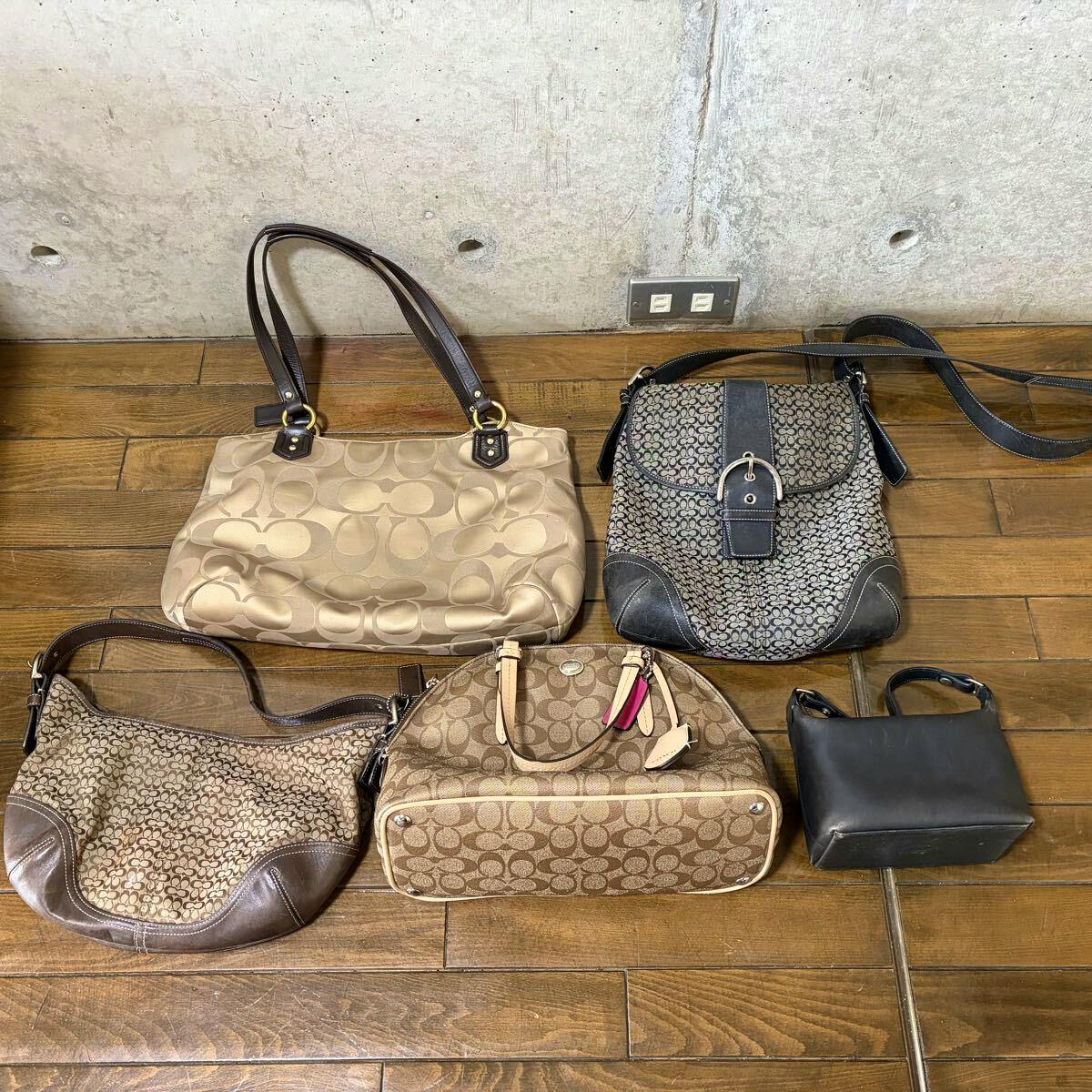 Five Coach bags arranged on a wooden floor showing the five-piece set.