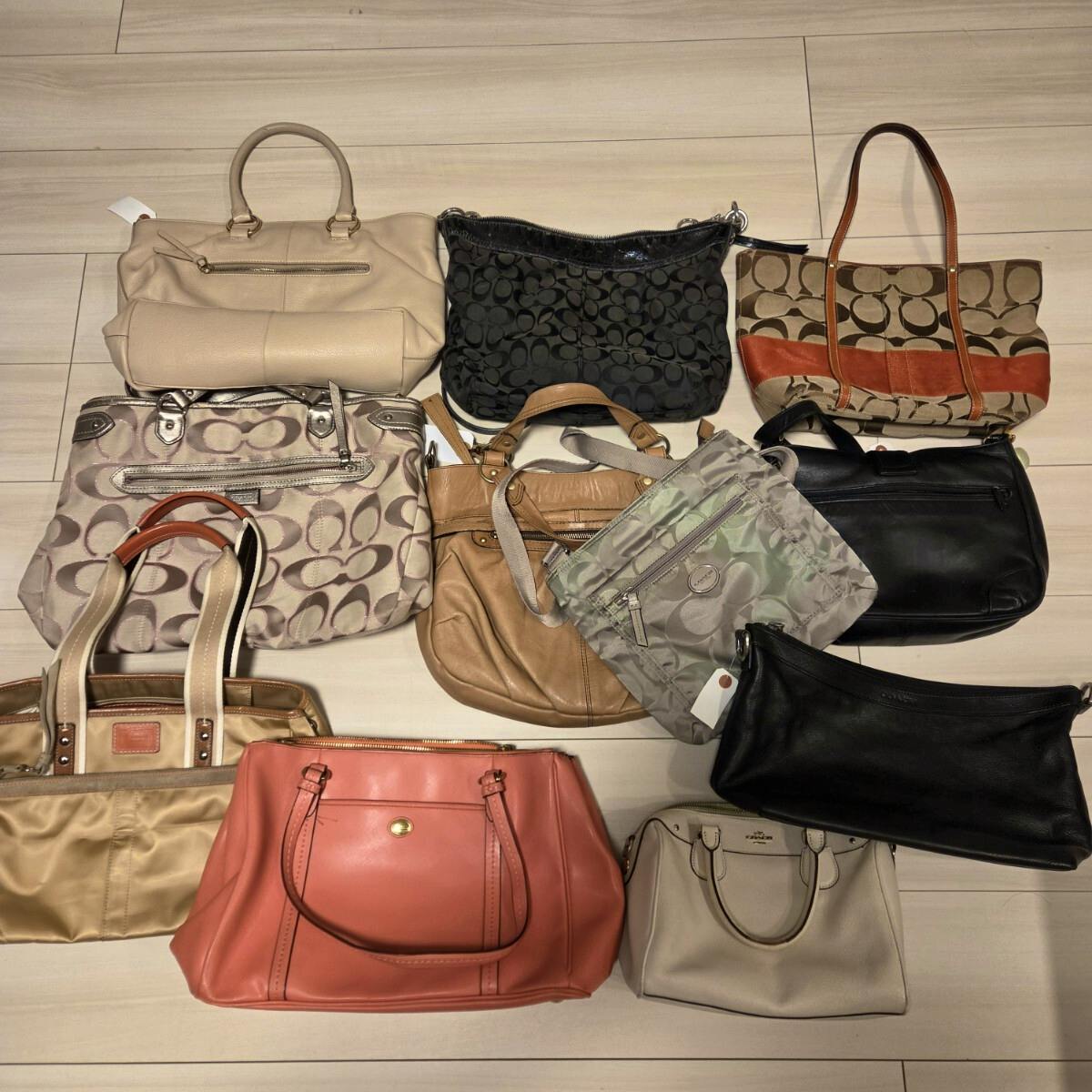 Top-down photo of a set of 11 Coach handbags and shoulder bags arranged on a light floor.