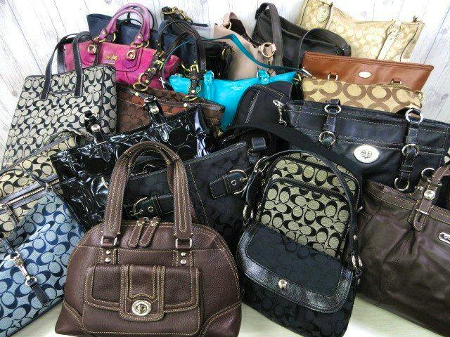 A group of Coach handbags and shoulder bags arranged together, shown as a multi-piece lot.
