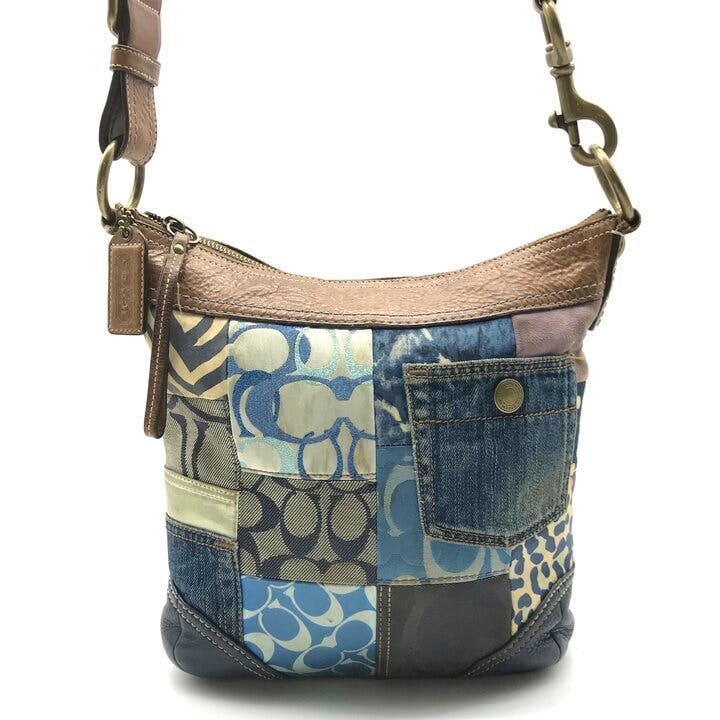 Front view of a multicolor Coach patchwork shoulder bag with leather trim and a denim front pocket.