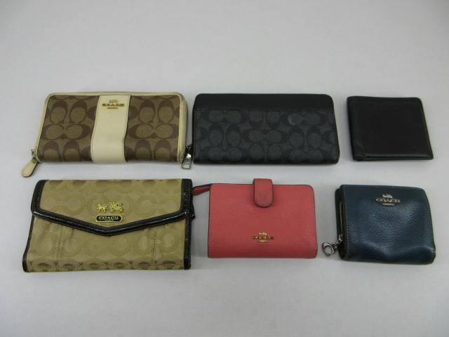 Six COACH wallets (a 6-piece set) arranged on a white surface, showing signature canvas and leather styles.