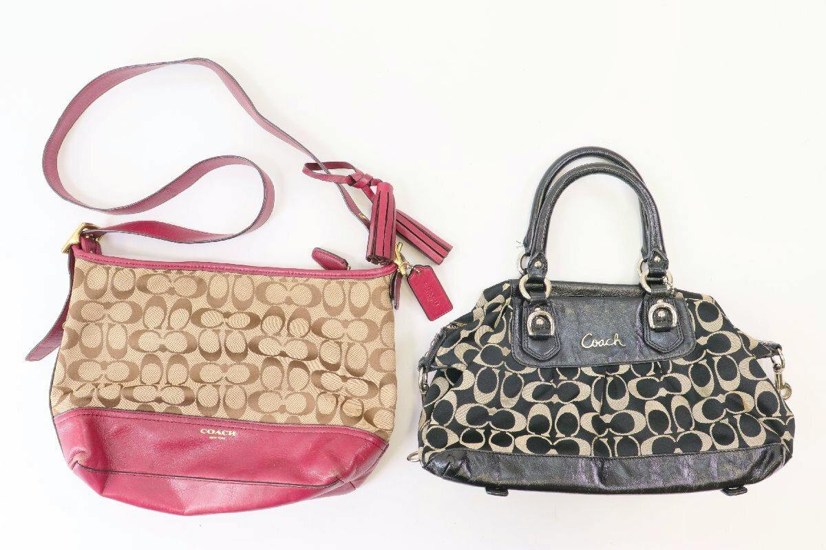 Two COACH signature shoulder/handbags displayed on a white background: one beige canvas with pink leather trim and one black canvas with the Coach signature pattern and black leather trim.