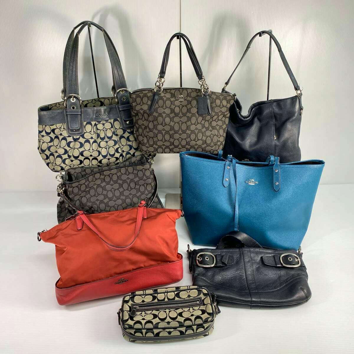 Eight Coach bags, including a small signature pouch, arranged on a white background.