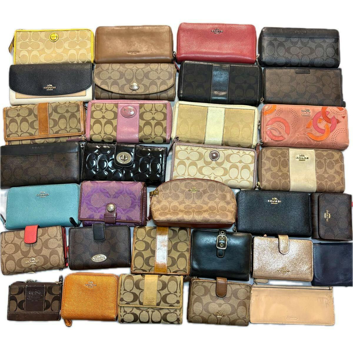 Many COACH wallets and pouches arranged in a grid, showing signature canvas and leather styles.