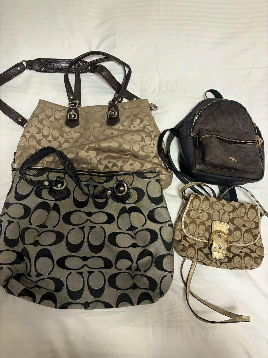 Four Coach bags (backpack, shoulder bag, handbag, and tote) with the signature C pattern arranged on a white background.