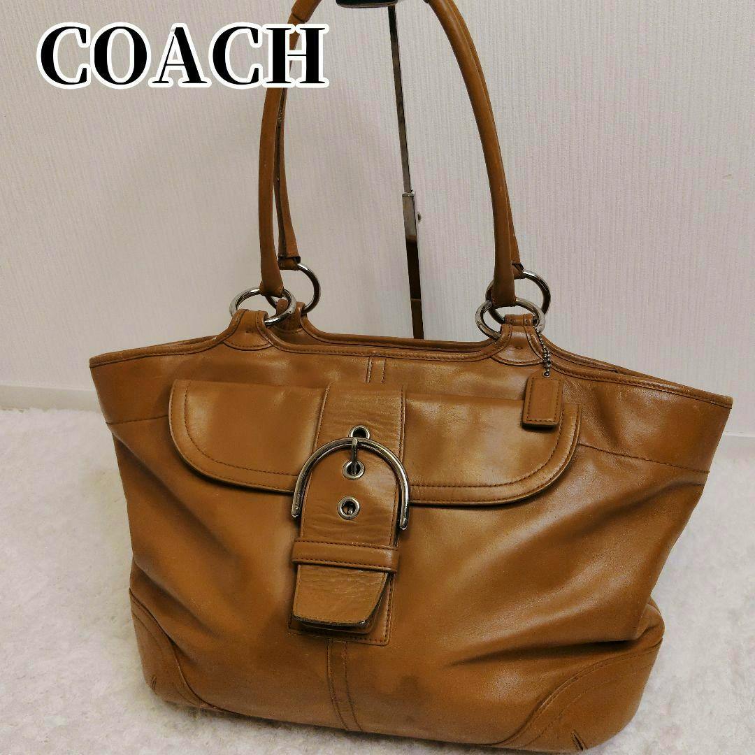 Front view of a brown Coach SOHO leather tote bag with buckle detail and double shoulder straps.