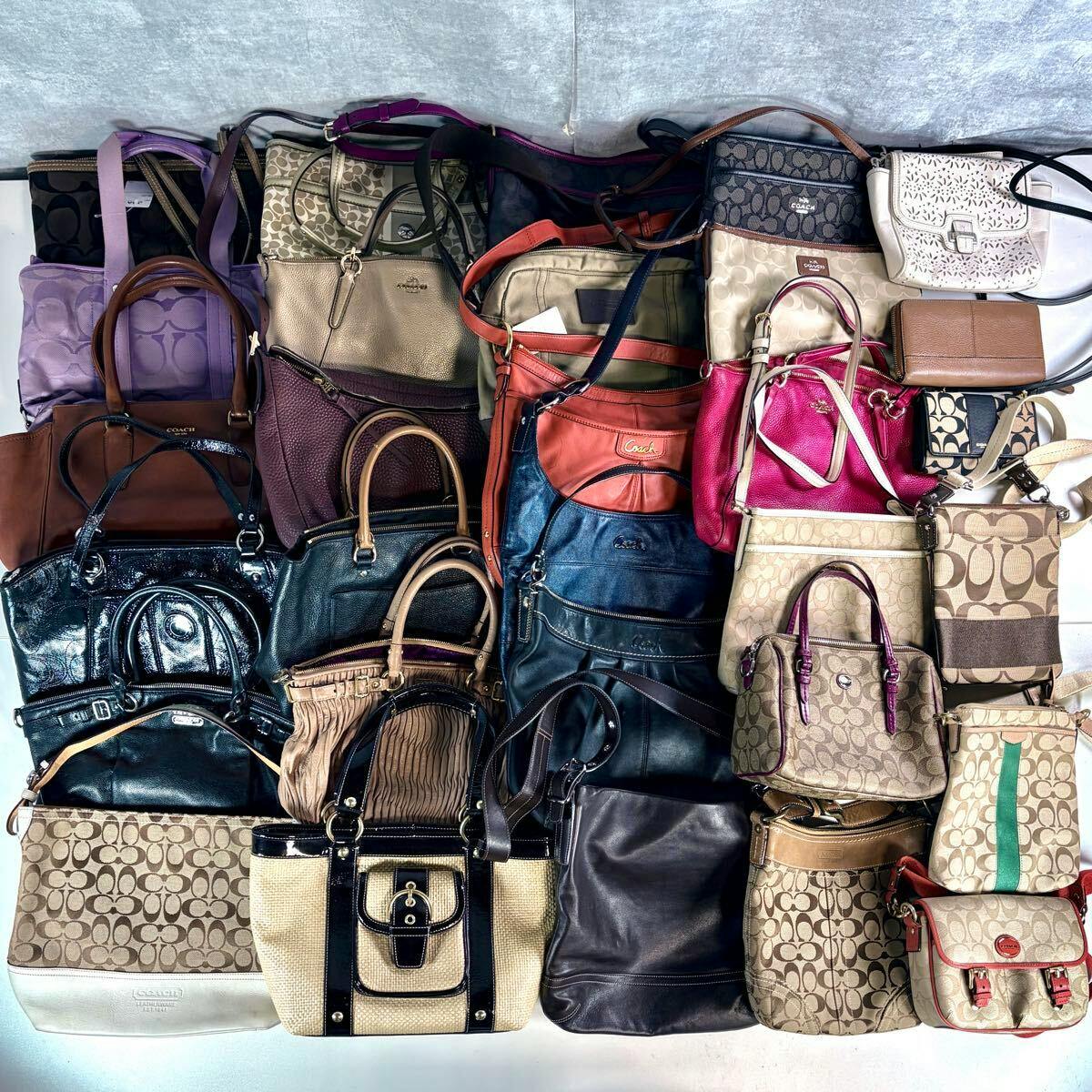 Top-down photo showing numerous Coach handbags and crossbody bags arranged together in various colors, patterns, and leathers.