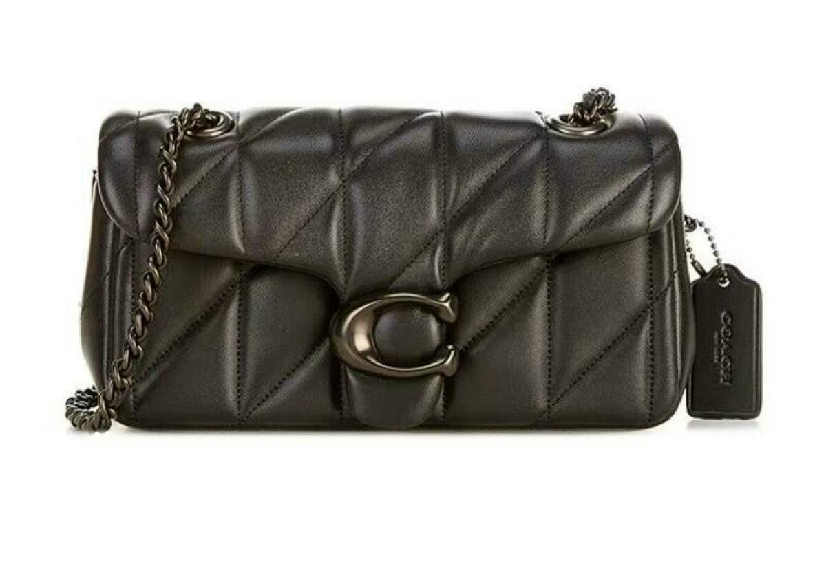 Front view of the black COACH Tabby 20 quilted chain shoulder bag with black hardware and a Coach hangtag.