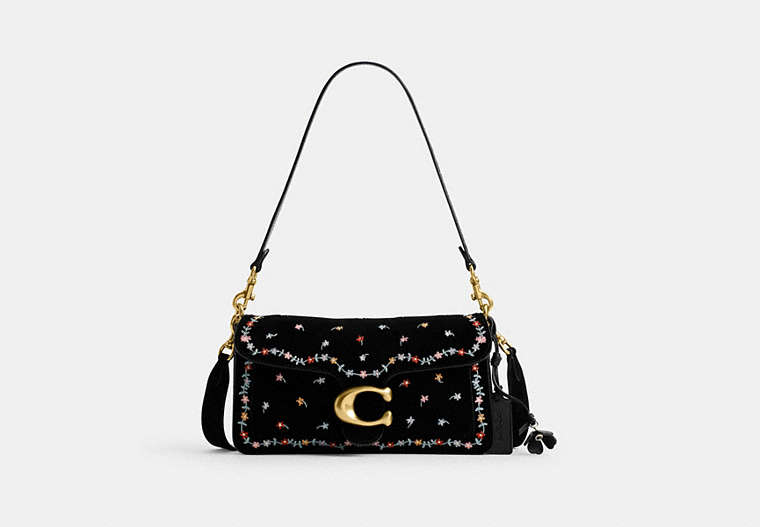 Front view of a black suede shoulder bag with dainty multicolored embroidery, a gold 'C' clasp, and an attached shoulder strap.