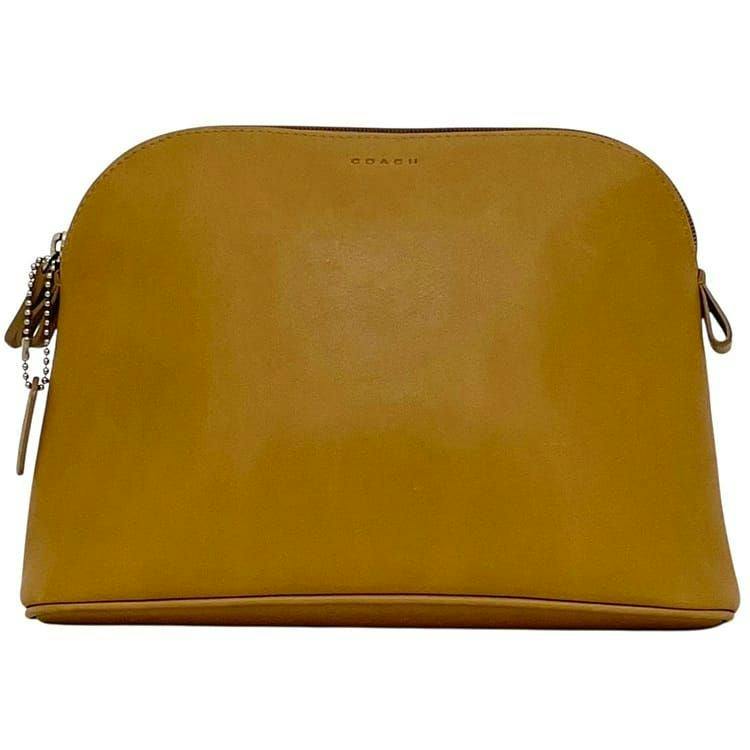 Front view of a beige COACH leather pouch with a top zipper and small logo.