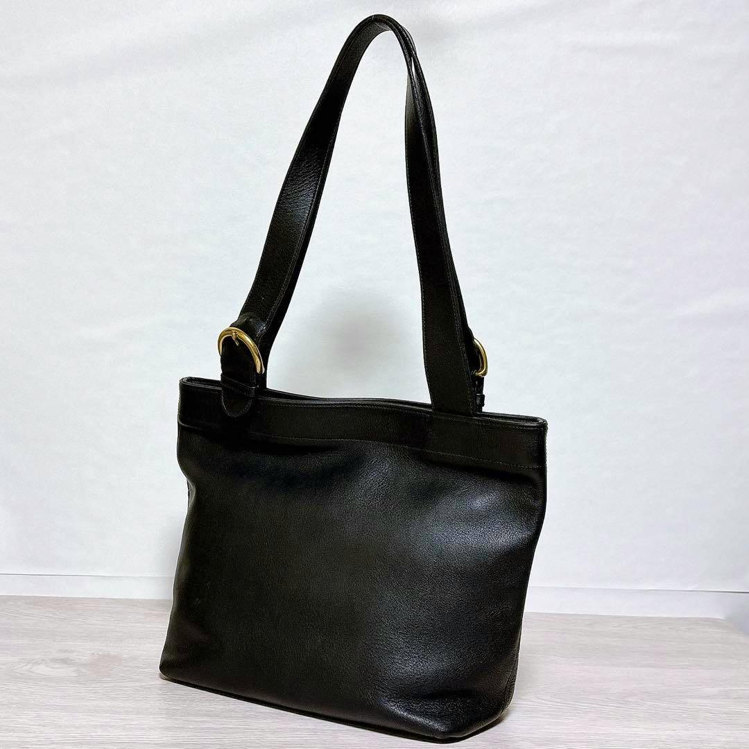 Black cow leather COACH vintage tote bag with shoulder straps shown against a white background.