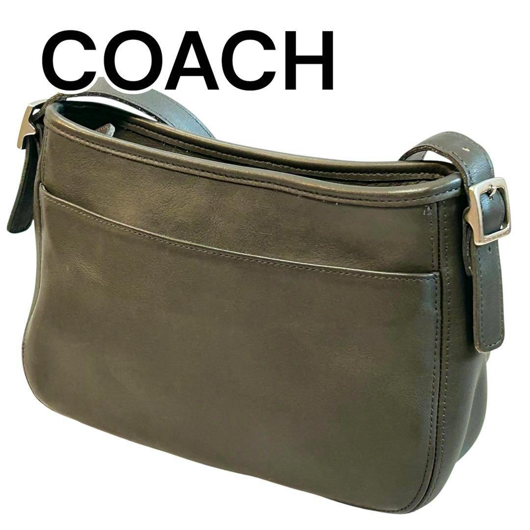 Gray COACH cow-leather shoulder bag shown from the back with an exterior slip pocket and an adjustable strap.