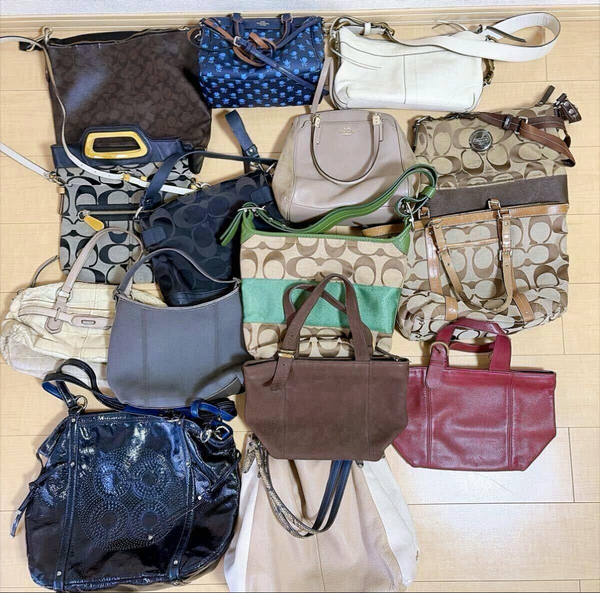 Top-down photo of a set of Coach bags and totes arranged on a wooden floor, showing various colors and signature patterns.