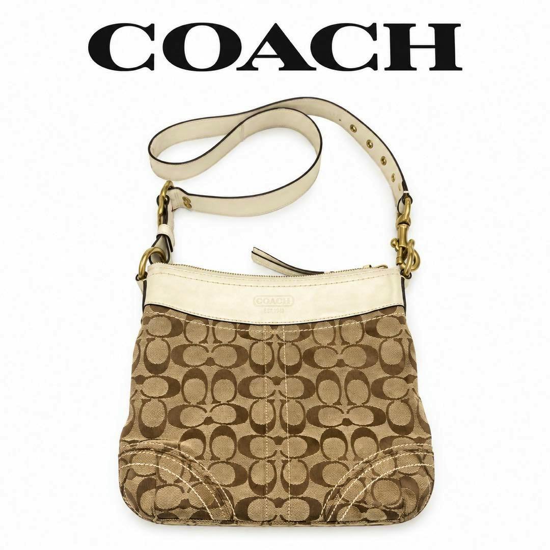 Beige Coach signature canvas shoulder bag with cream leather trim and adjustable strap on a white background.