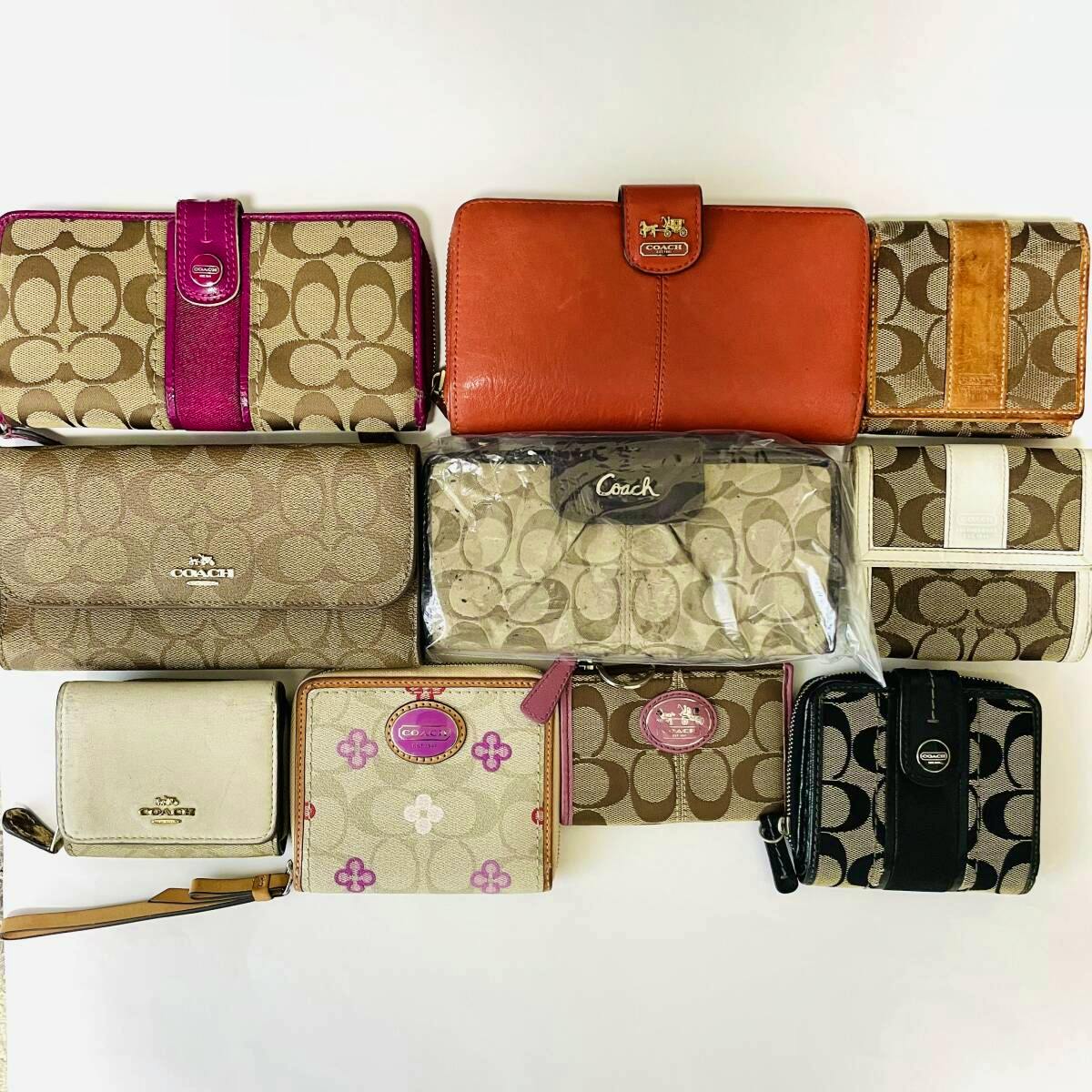 Ten COACH wallets and coin cases of various styles and patterns arranged on a white background.