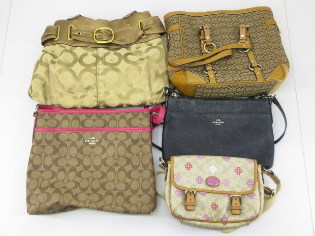 Five COACH women's bags arranged together on a white background.
