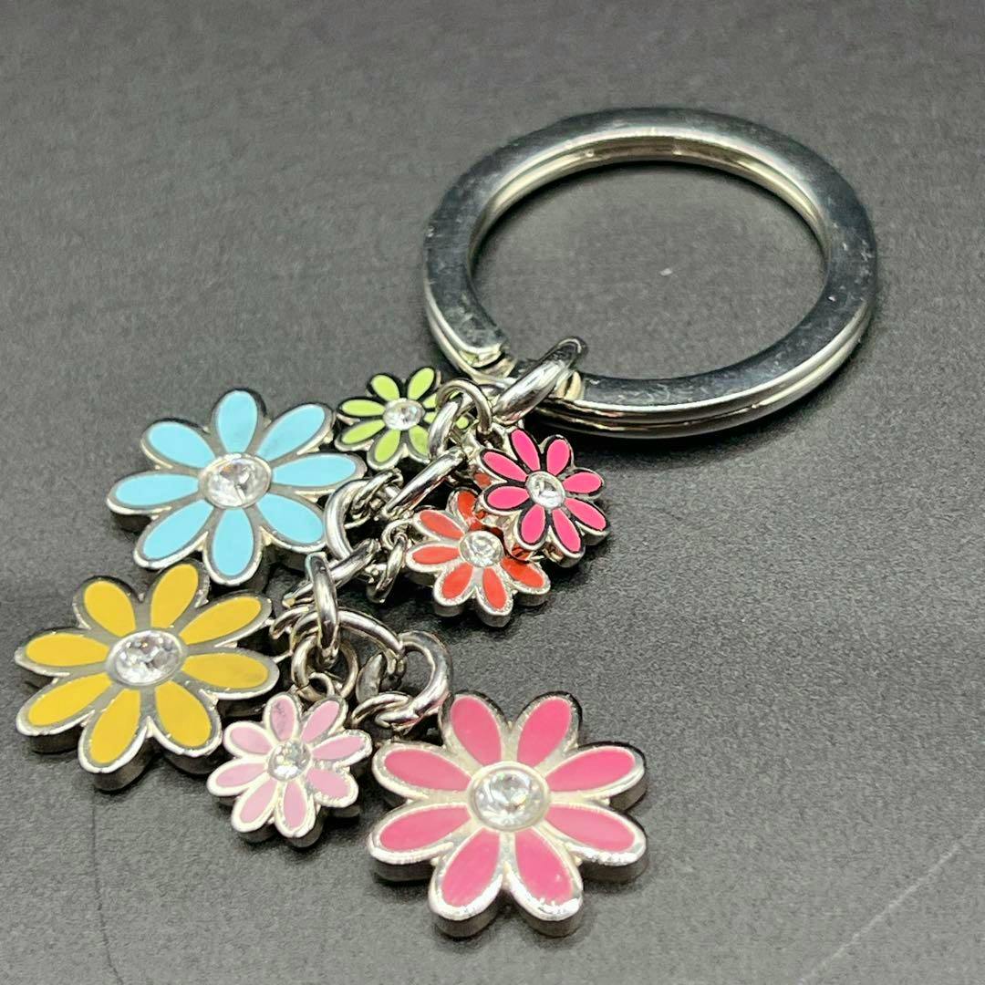 COACH Y2K multicolor flower bag charm on a metal ring with several enamel daisy charms.