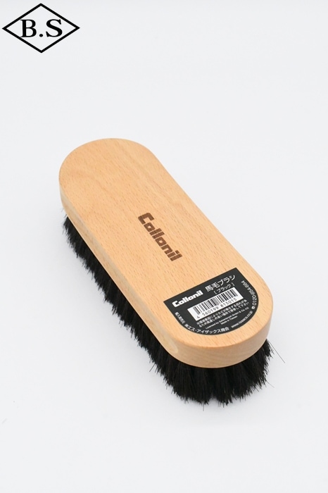 Collonil horsehair cleaning brush with a beech wood handle and black bristles on a white background.