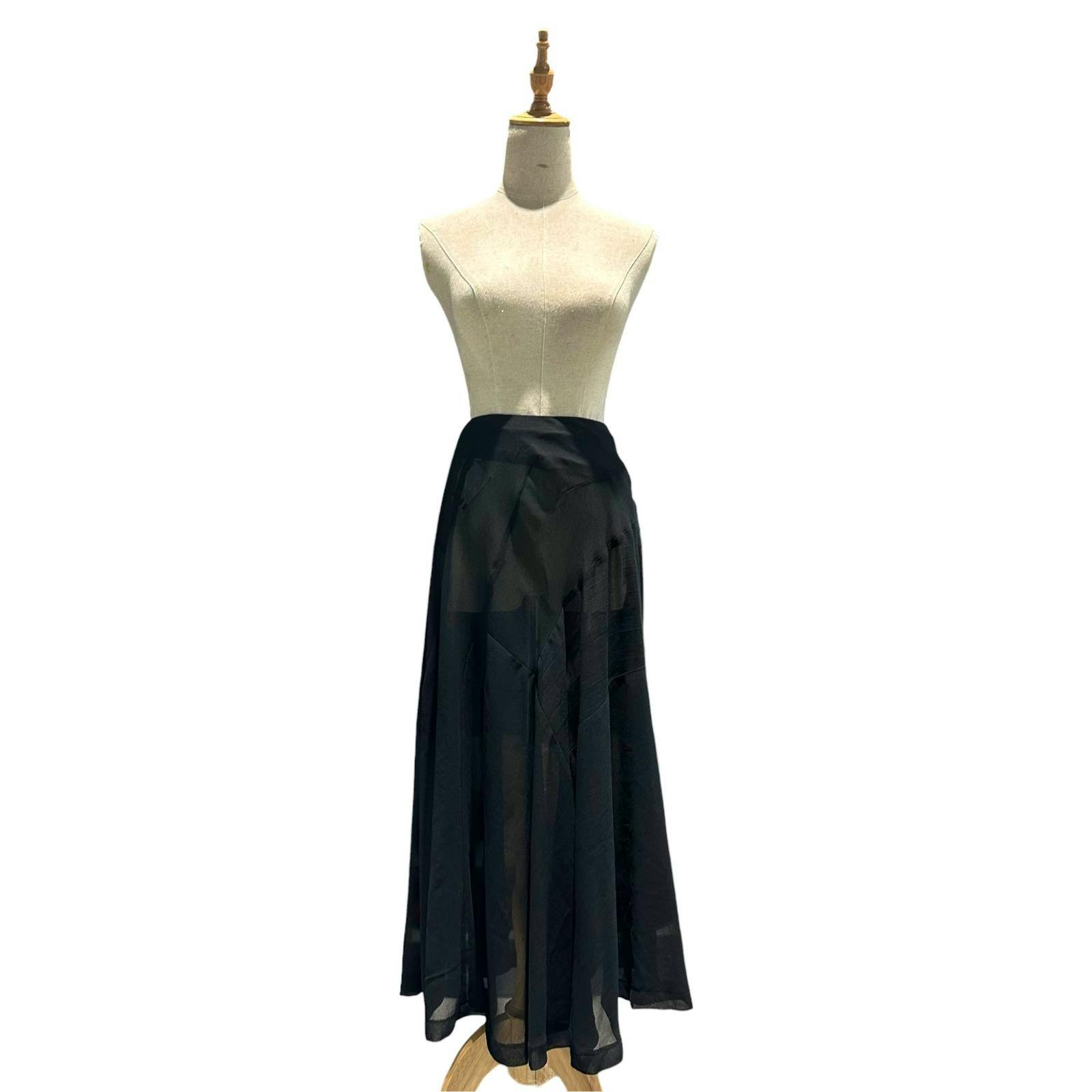 Black sheer skirt displayed on a dress form against a white background.
