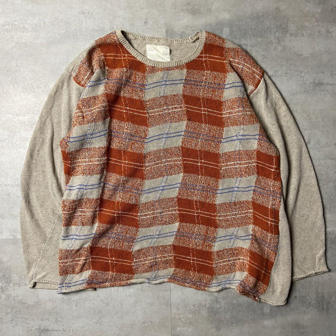 Front flat-lay of the men's linen-cotton check knit showing a red-orange check panel with beige sleeves.