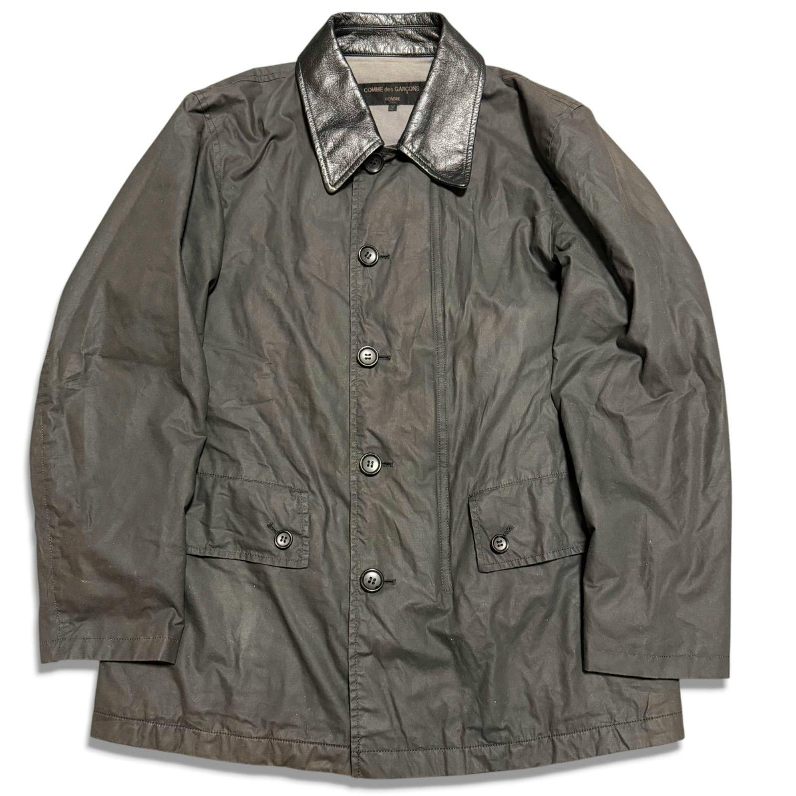 Front view of a black men's Comme des Garçons Homme jacket with a leather collar, button closure and flap pockets.