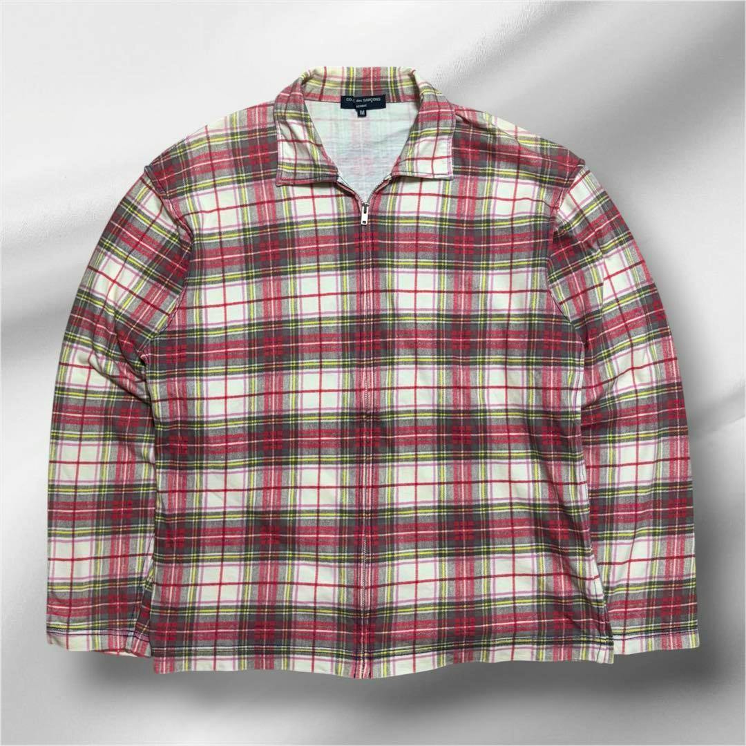 Front view of a men's Comme des Garçons Homme red-and-white check cotton zip shirt laid flat showing collar and zipper.