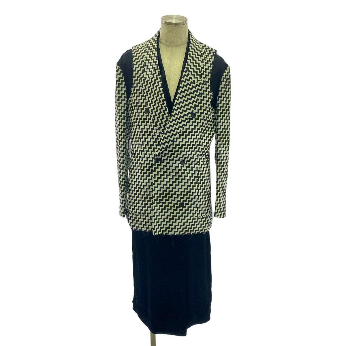 Front view of the men's wool jacket with black and white geometric pattern displayed on a mannequin.