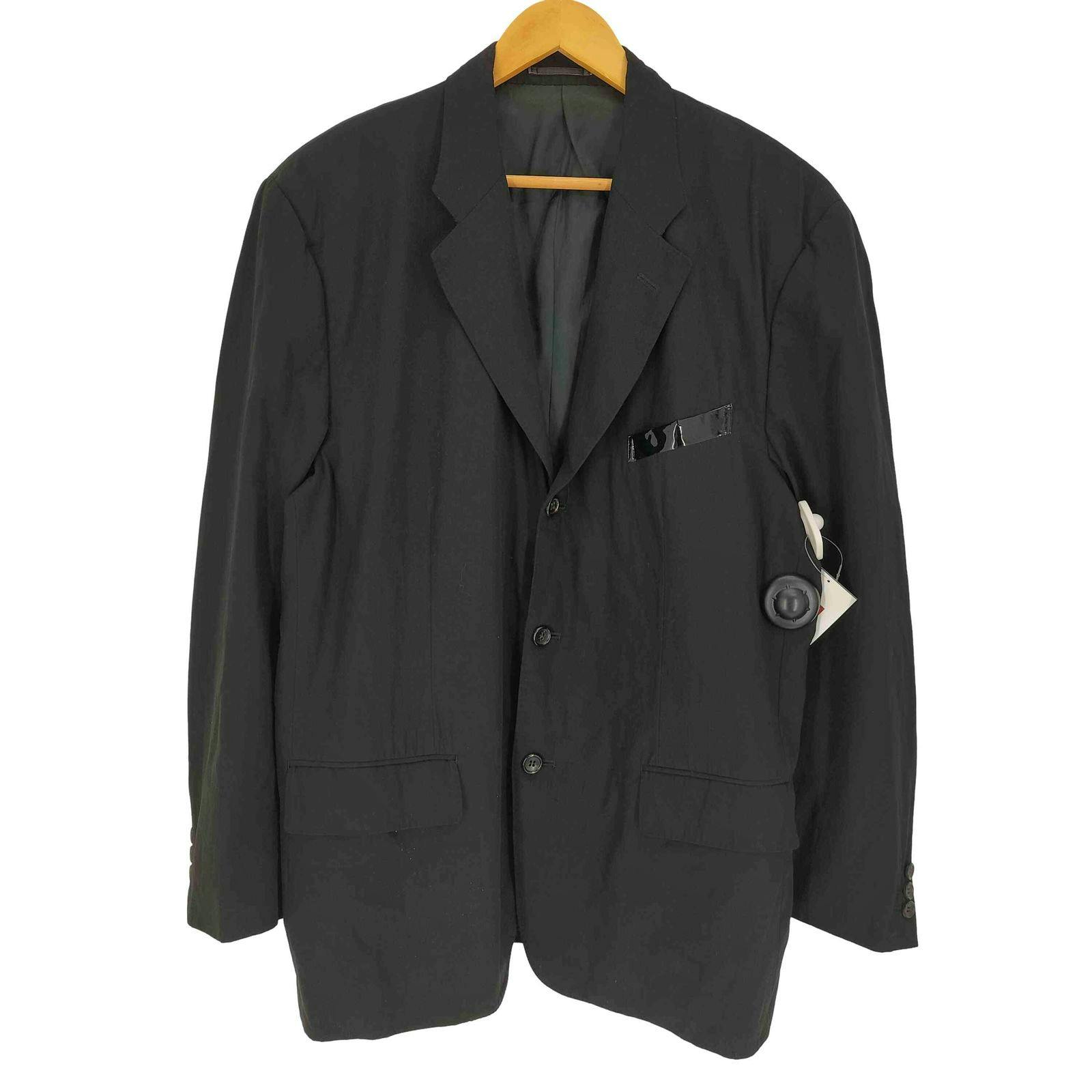 Front view of the black single-breasted tailored jacket on a wooden hanger showing the pocket and attached tags.