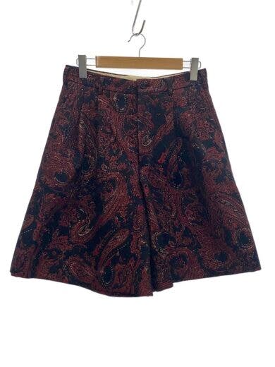 COMME des GARCONS HOMME PLUS women's polyester skirt with a paisley pattern hanging on a hanger against a white background.