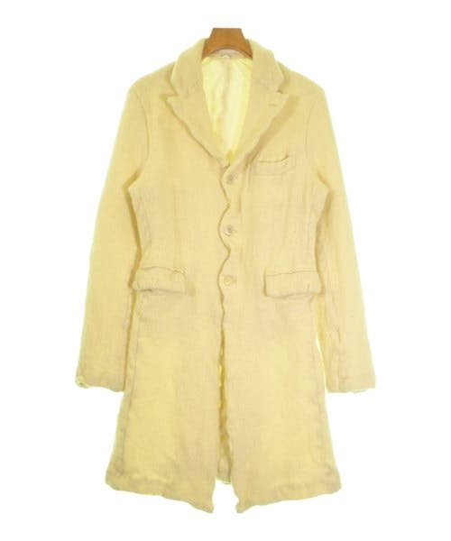 Front view of a light-colored COMME des GARCONS HOMME PLUS men's wool coat on a hanger.