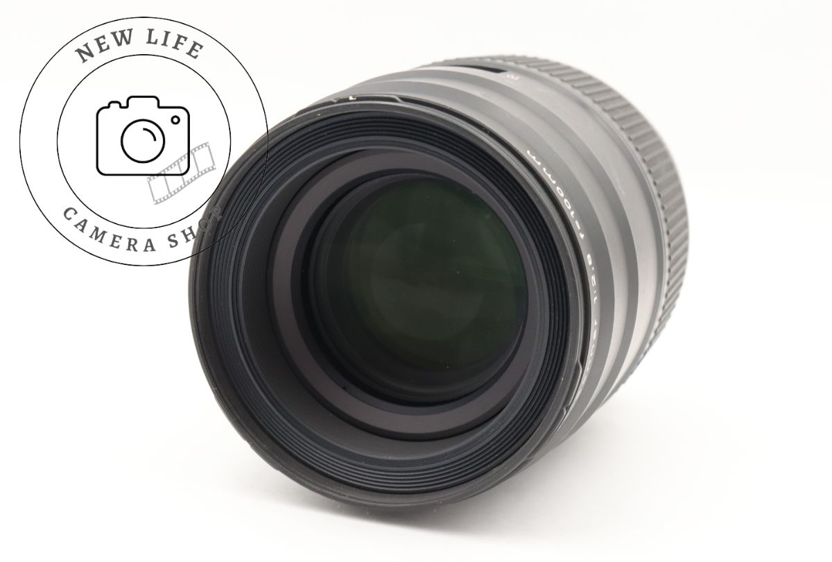 Front view of the CONTAX Carl Zeiss Makro-Sonnar 100mm F2.8 camera lens on a white background with a circular watermark.