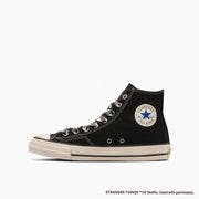 Black high-top canvas sneaker shown in profile on a white background, with an aged white midsole and round ankle patch.
