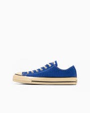 Side profile of a blue All Star Aged AC OX low-top canvas sneaker on a white background.