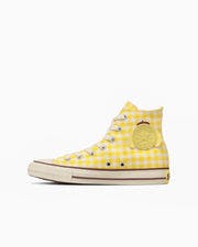 Yellow All Star Hi canvas sneaker with Pompompurin character print shown in side profile on a white background.